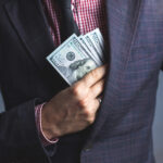 Businessman in Suit Hides Dollars - UDAP - McCune Law Group