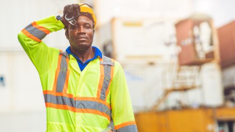 African American black man sweating while working in factory