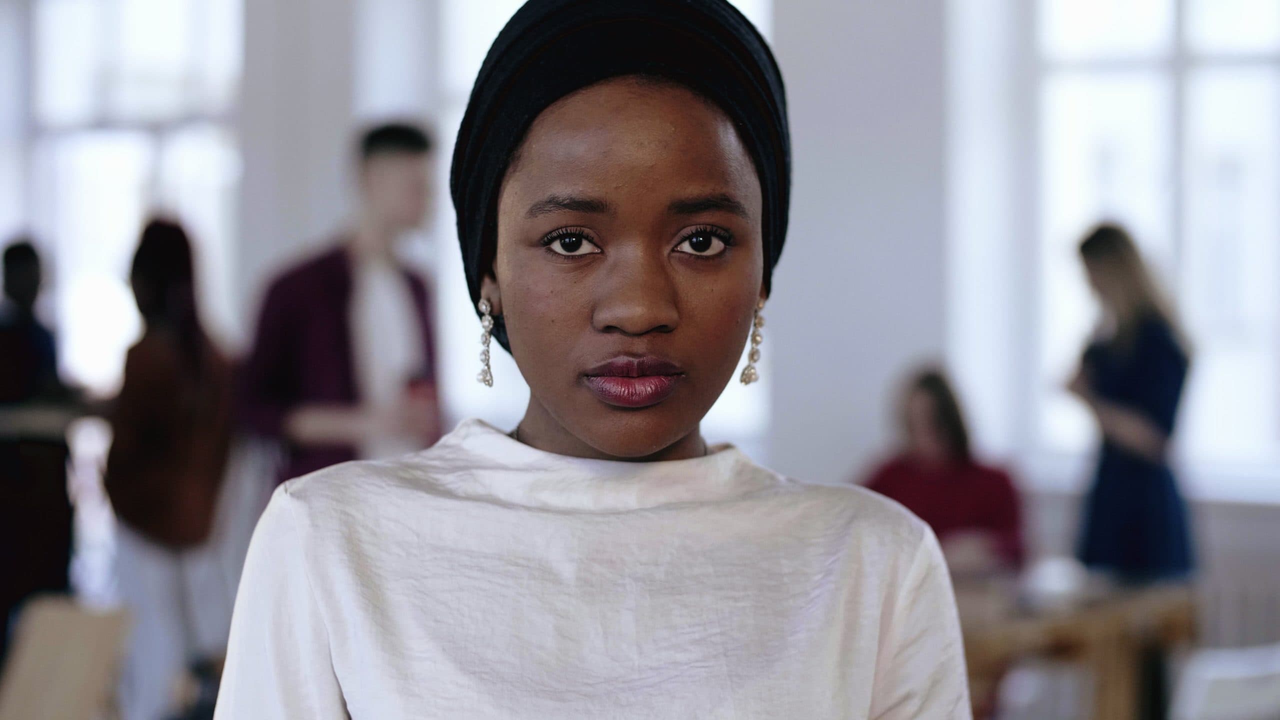 Black woman with head wrap in an office