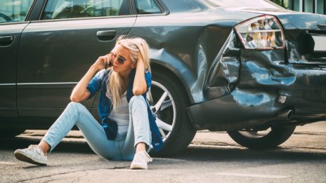 Young woman dealing with uninsured motorist insurance in collision