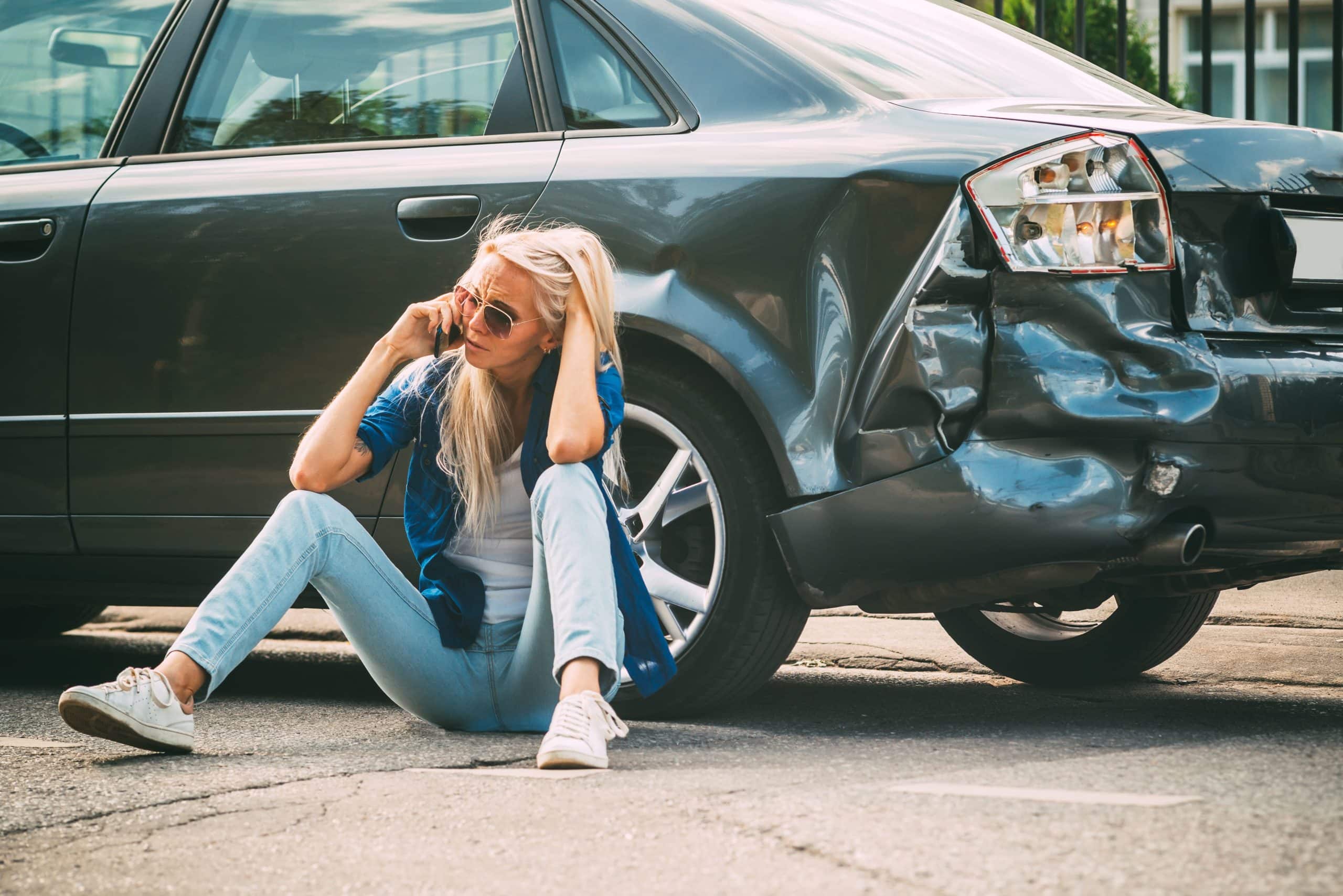 Young woman dealing with uninsured motorist insurance in collision