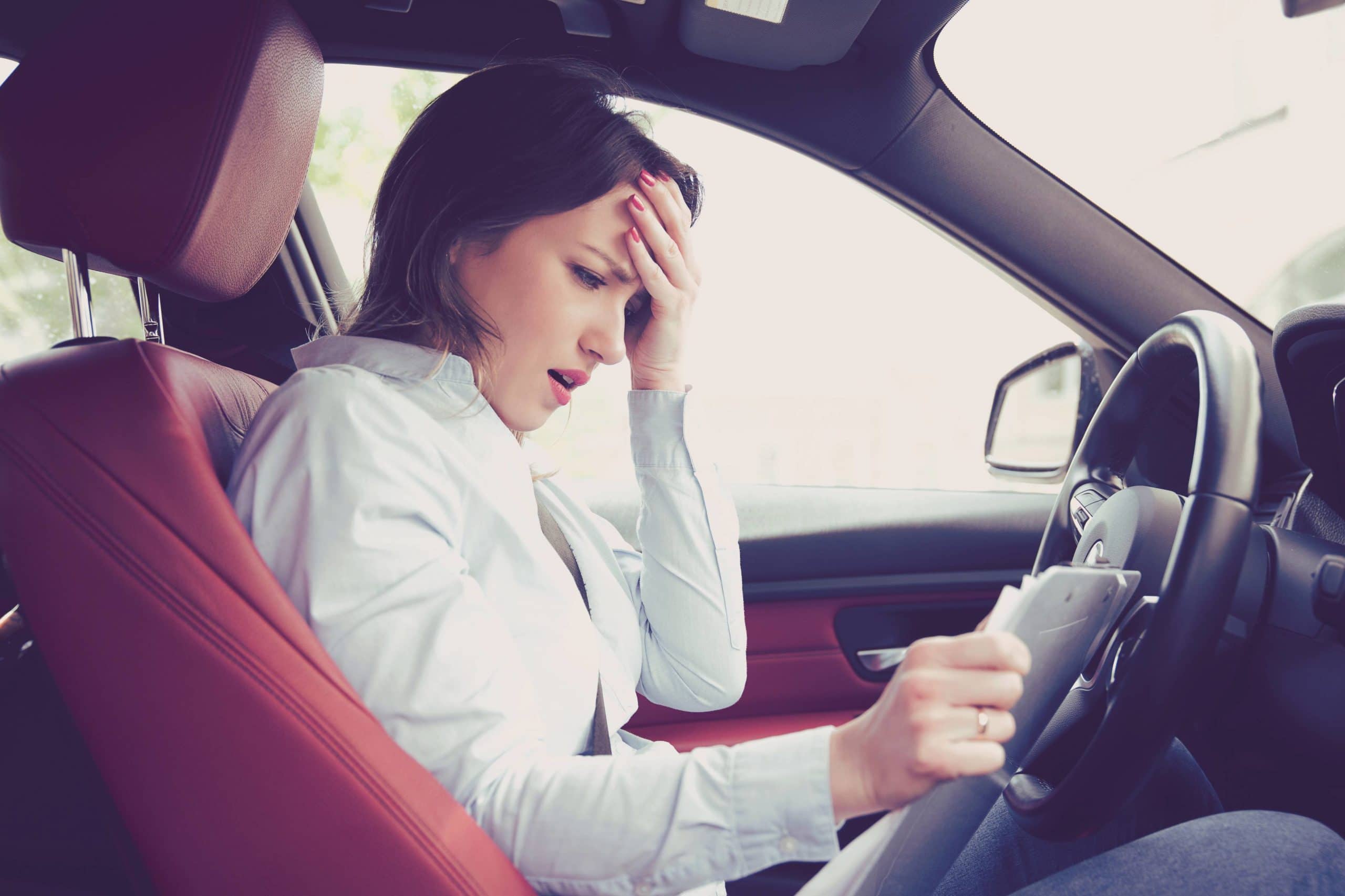 Woman in car experiencing pain