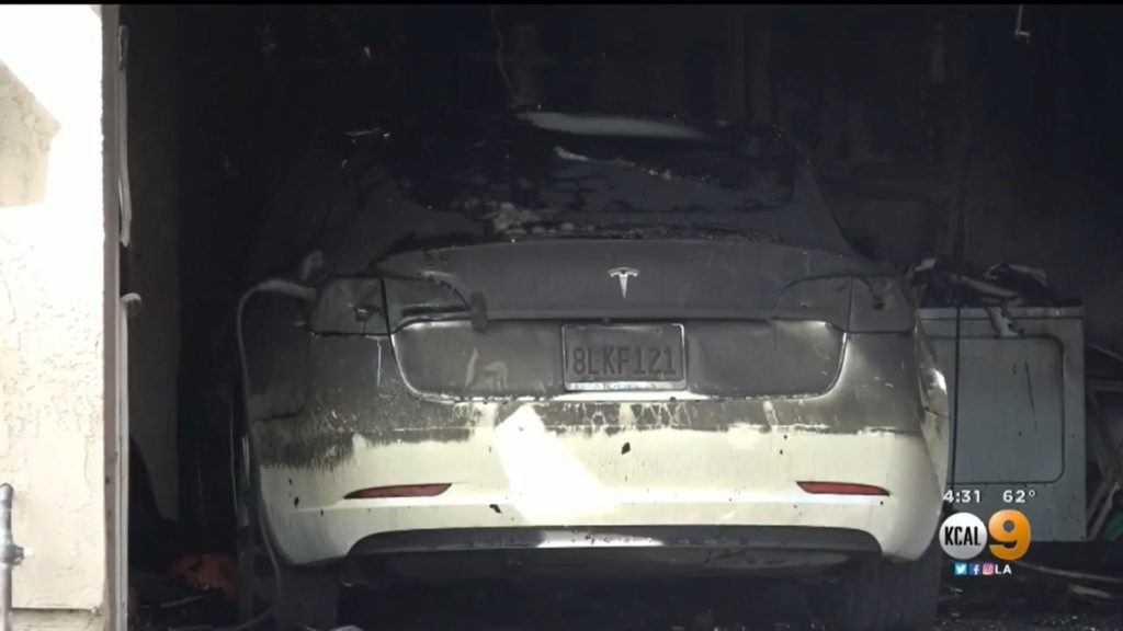 burned white Tesla after it caught fire