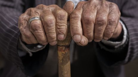 Elderly Hands holding cane