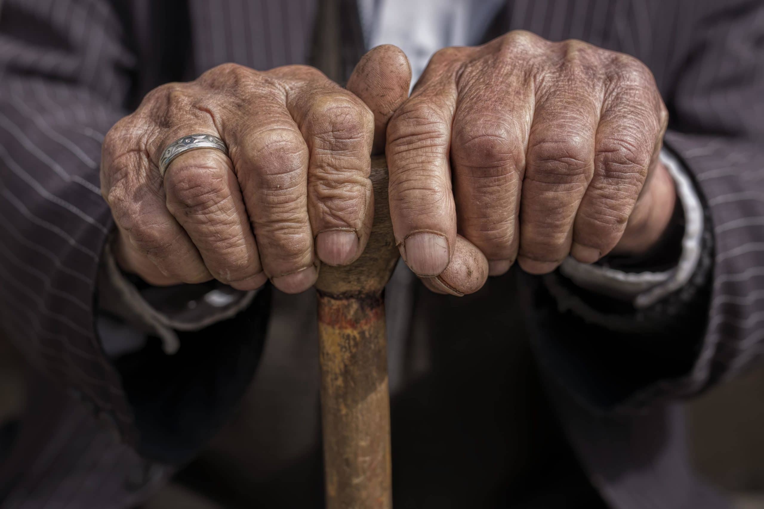 Elderly Hands holding cane