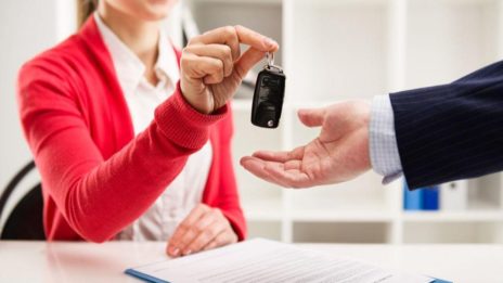 Dealer handing over car keys to customer