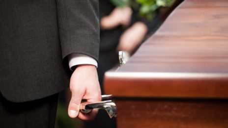 Pallbearer carrying casket at funeral