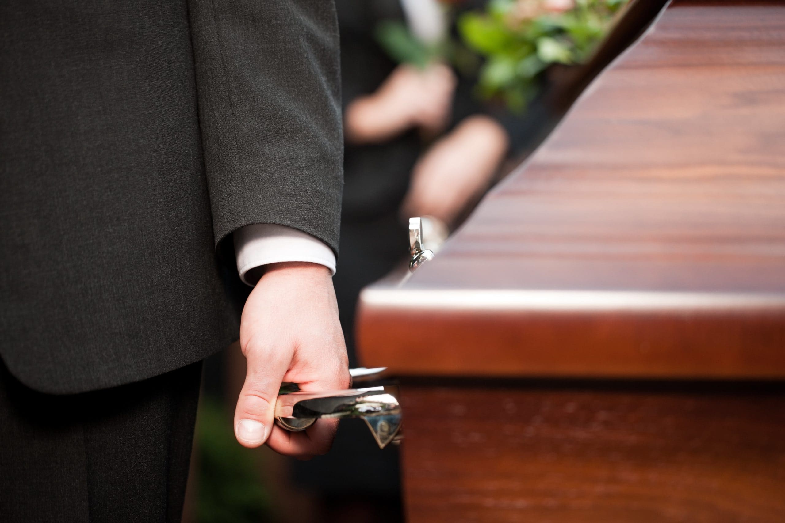 Pallbearer carrying casket at funeral