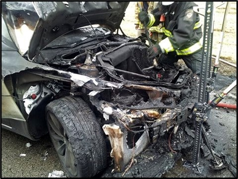 Firefighters investigating Burned Tesla Model S