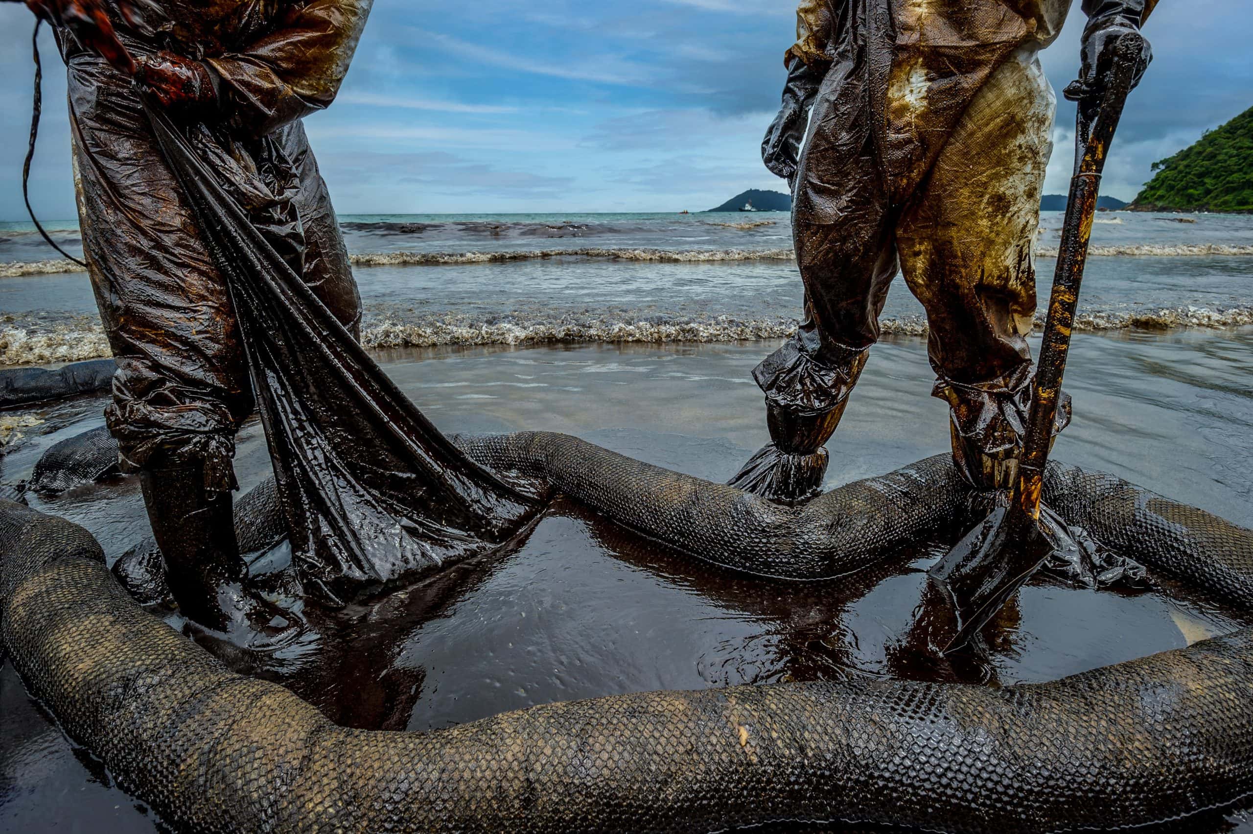 Cleanup crew on beach for orange county oil spill