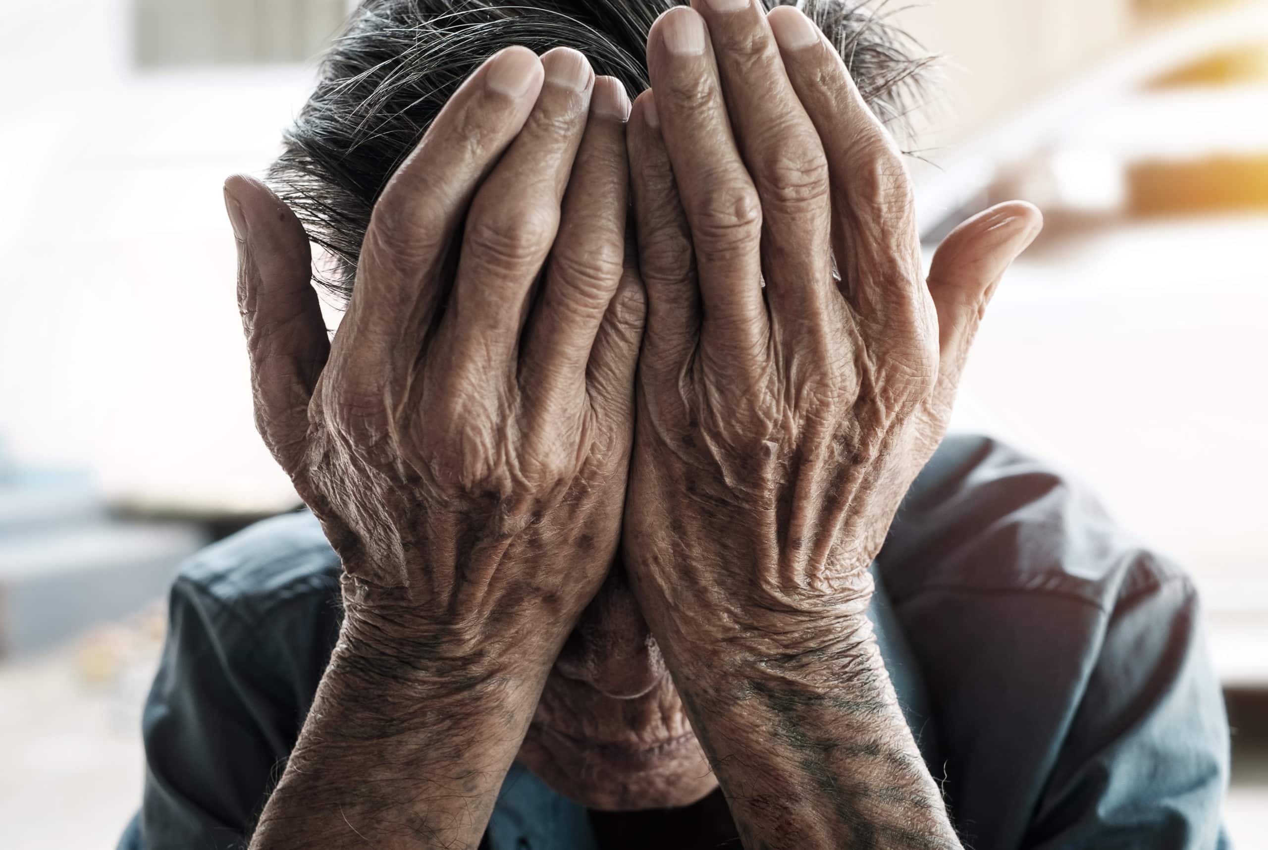 Old Man Covering his face