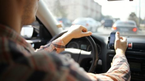 Rideshare driver looking at phone while driving