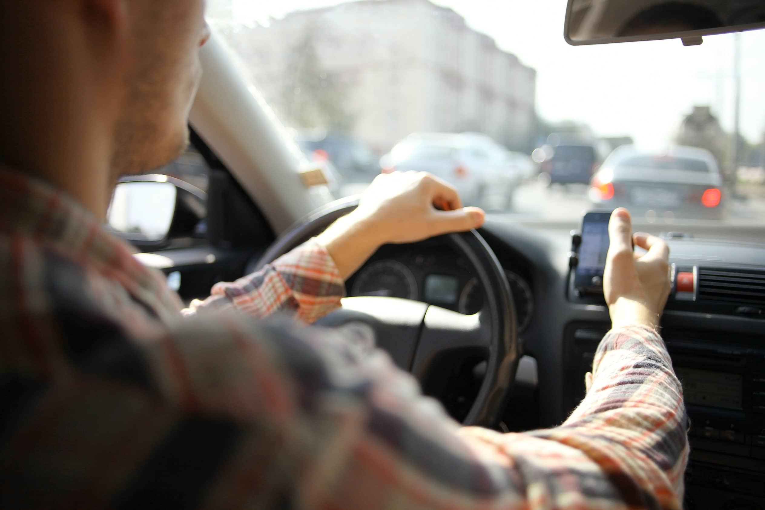 Rideshare driver looking at phone while driving